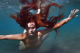 Enjoy a red-haired underwater and lesbians