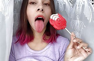 Naughty sister-in-law sucks a lollipop and demonstrates her lengthy hot sexy tongue